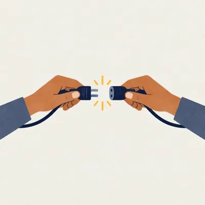 Two hands connecting two cable ends with a small spark.